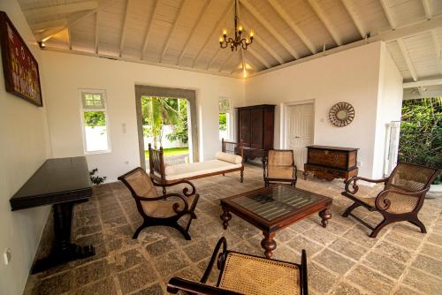a living room filled with furniture and a table at The Villa By R in Balapitiya