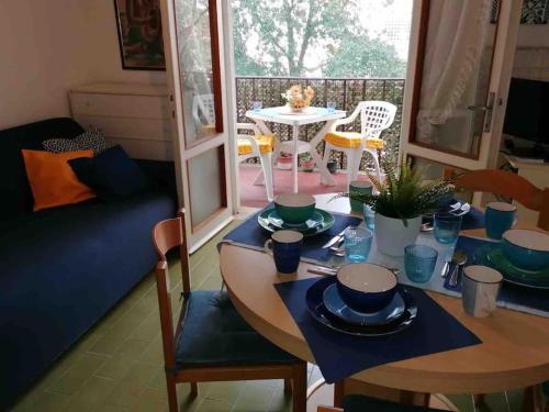 a living room with a table and chairs and a dining room at Immobile Vintage a Grado Pineta in Grado-Pineta