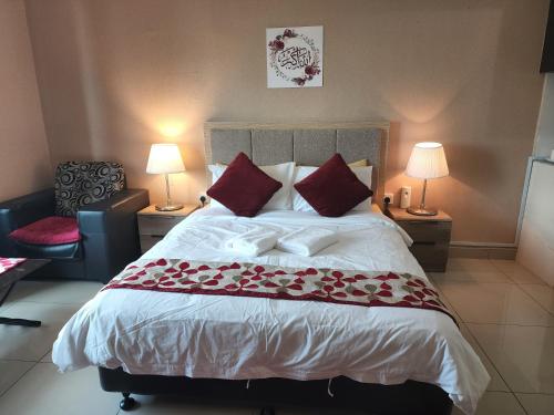 a bedroom with a large bed with red pillows at The Viana Apartment 1 in Kota Bharu