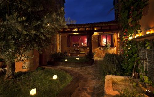 a house with a patio at night at El Planeta Escondido in Losana de Pirón