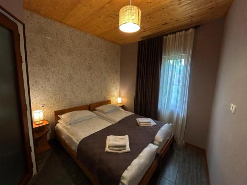 a bedroom with a large bed with two towels on it at Hotel VIM in Sighnaghi in Sighnaghi