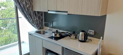 a kitchen with a sink and a counter top at Arcadia beach resort in Pattaya South