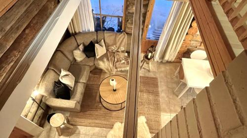 an overhead view of a living room with a table at Nilimukka log cabin near Levi center in Levi