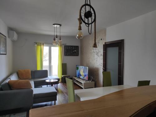 ein Wohnzimmer mit einem Sofa und einem Esstisch in der Unterkunft Apartment Uphill Vukovic in Bar