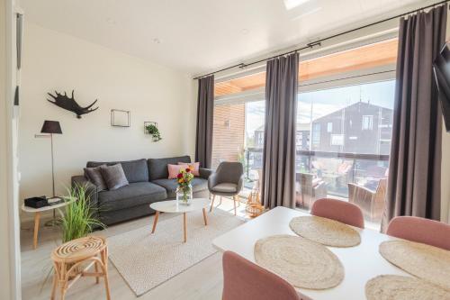 a living room with a couch and a table at Apartment Aurinkoranta D7 saunallinen kaksio Kalajoki in Kalajoki