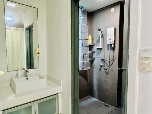 a bathroom with a shower and a sink at KLCC One Bedroom apt & Studio in Kuala Lumpur
