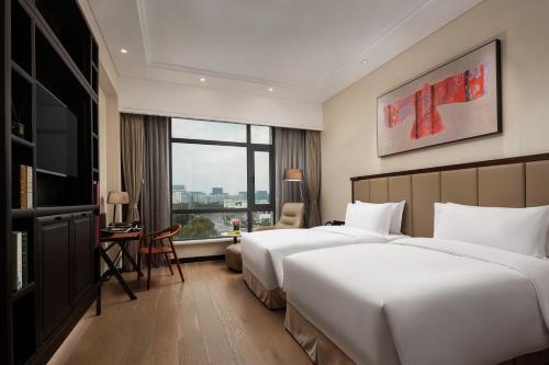 a hotel room with two beds and a window at The Senz Hotel & SPA in Shanghai