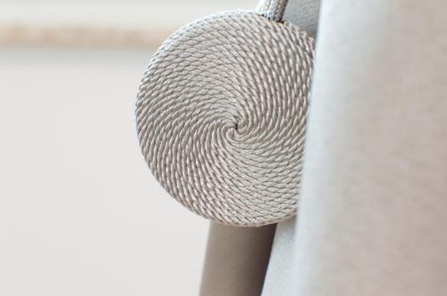 a coil of rope hanging from a wall at Walls of Piran Apartments and Rooms in Piran