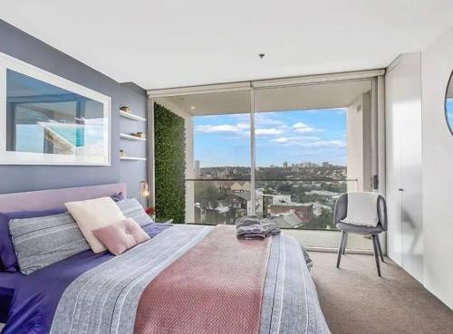 a bedroom with a bed and a large window at Stylish 2 Bed Apt +24/7 Concierge + Pool + Sauna in Sydney
