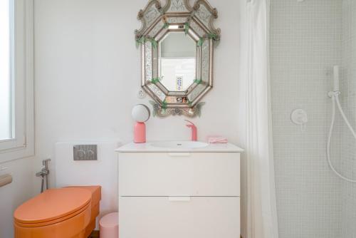 a bathroom with a toilet and a sink and a mirror at Pop-Zen Penthouse Madrid in Madrid