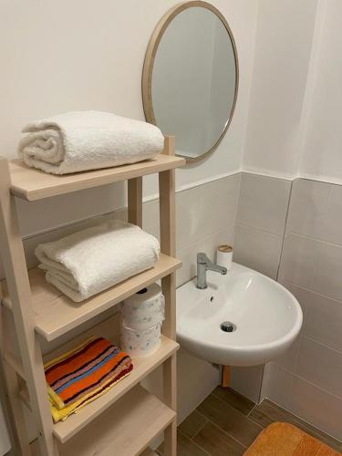 a small bathroom with a sink and a mirror at Casa Vacanze Viola in San Benedetto del Tronto