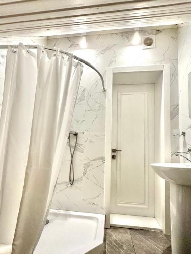 a bathroom with a shower curtain and a sink at Salut in Bukovel