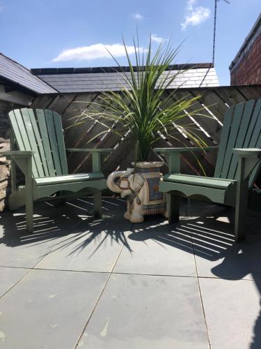 two green chairs sitting next to a fire hydrant at Number 19, Cardigan in Cardigan