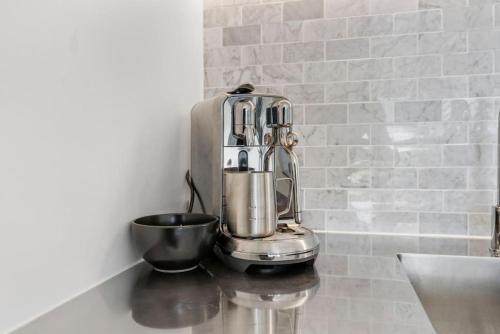 a kitchen mixer sitting on a counter next to a wall at Amazing Western Springs position in Auckland