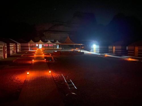 a row of lights in a parking lot at night at Wadi rum Sunrise luxury camp in Wadi Rum