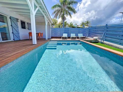 a swimming pool in front of a house at Maison Ti Case, private pool, next to Pinel Island in Cul de Sac