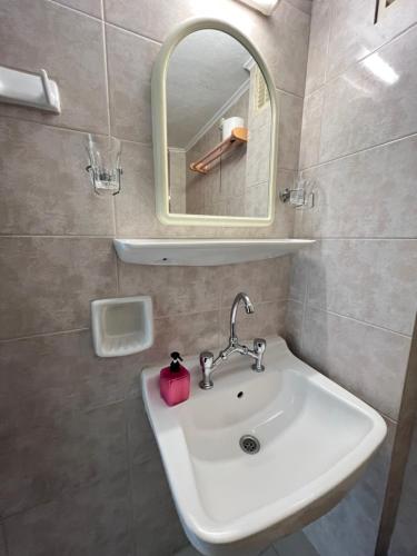 a bathroom with a sink and a mirror at Asterias Hotel - Seafront in Parikia