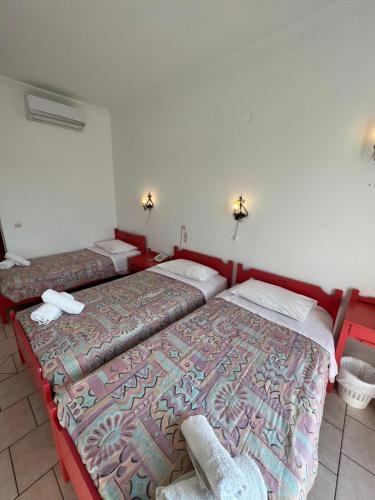 a room with two beds in a room at Asterias Hotel - Seafront in Parikia