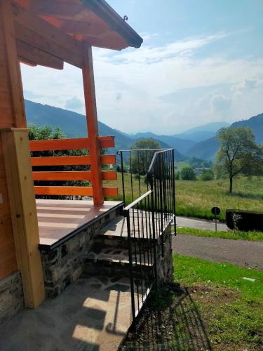 a porch of a cabin with a view of the mountains at CHALET SIMONETTA - Locanda da Tullio in Capovalle