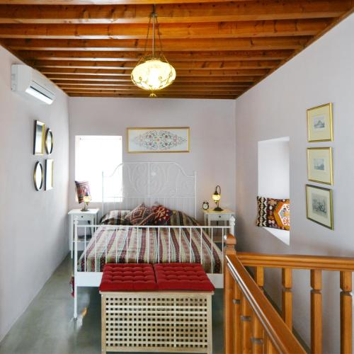 a bedroom with a bed and a chandelier at Casa Lindos in Lindos