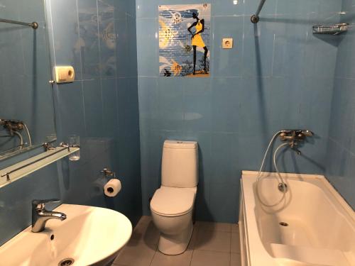a bathroom with a sink and a toilet and a tub at Cozy apartment in the city center in Tbilisi City