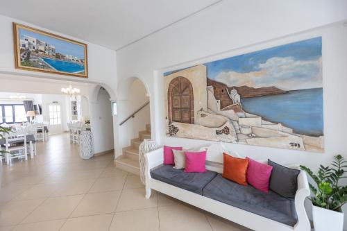 a living room with a couch and a painting on the wall at Hotel Star Santorini in Megalochori
