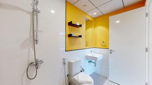 a bathroom with a toilet and a sink at Primestay - 3BR in Wasl Gate, close to Metro Station in Dubai