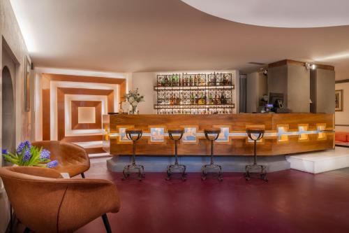 a bar in a room with chairs and a counter at Hotel Croce Di Malta in Florence