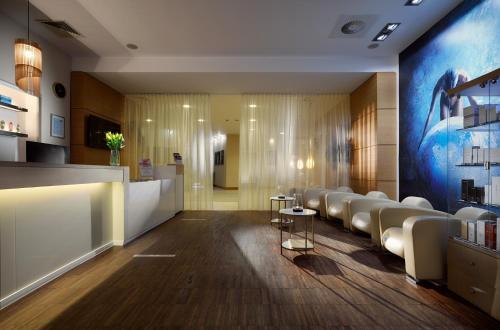 a lobby with a waiting room with white chairs at Arka Medical Spa in Kołobrzeg