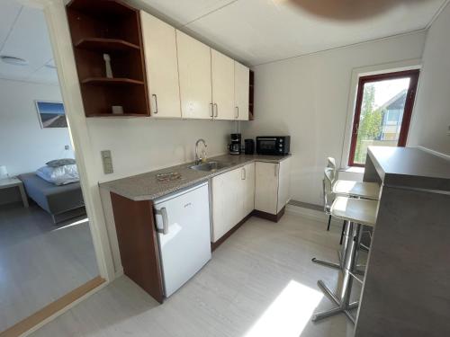a kitchen with a sink and a counter top at Oasen Samsø in Nordby