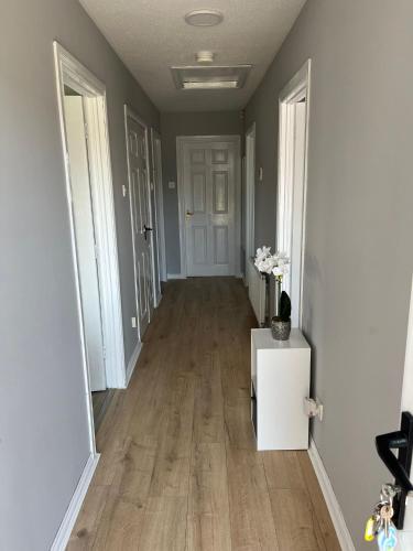a hallway of a home with wood floors and white walls at Armada Cottages Bundoran in Bundoran