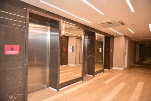 a hallway with glass doors in a building at Premium apartments - the star of Batumi Palace in Batumi