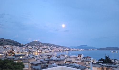 a view of a city with the moon in the sky at Hotel Qurku 2 in Sarandë