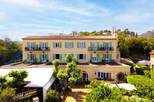an aerial view of a large house with blue windows at Le Relais d'Agay in Agay - Saint Raphael