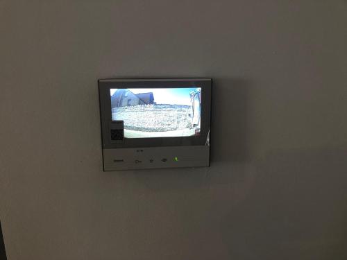 a flat screen tv on a wall in a room at Vakantiewoning De Kassei Geraardsbergen max 12personen in Geraardsbergen