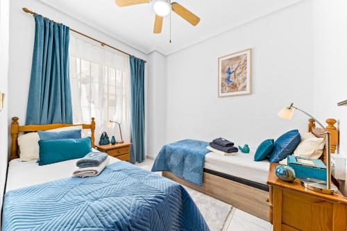 Postel nebo postele na pokoji v ubytování Apartament pod Palmami /Bajo las Palmeras
