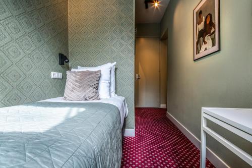 Giường trong phòng chung tại Hotel Atlantis Amsterdam