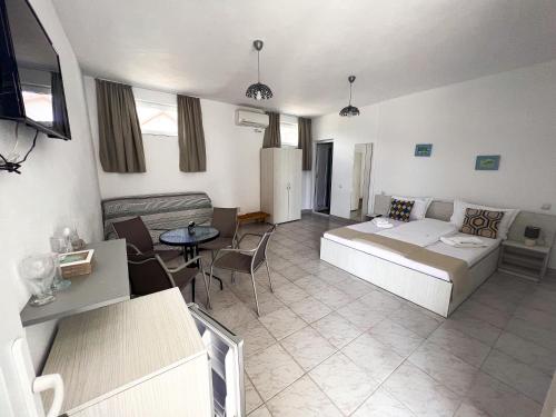 a living room with a bed and a couch at Vila Ithea in 2 Mai