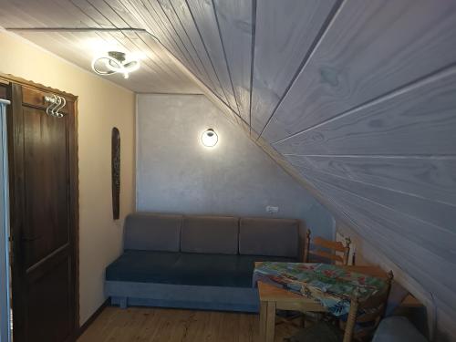 a living room with a couch and a table at Gama Spa in Władysławowo
