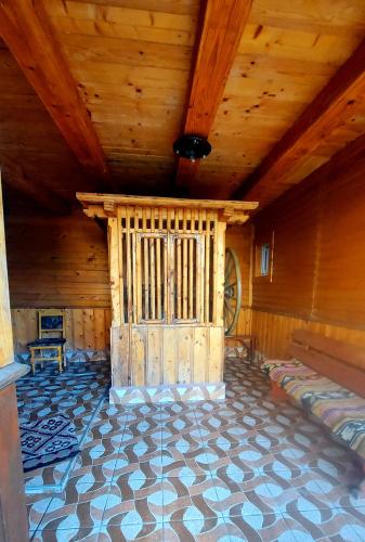 a large room with a wooden ceiling and a floor at PENSIUNEA BOCA VORONET in Voronet