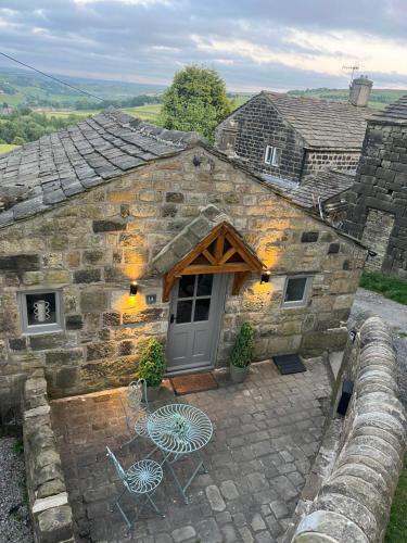 a stone house with two chairs and a door at Saltonstall Airbnb in Halifax