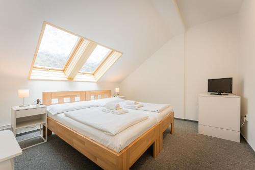 a bedroom with a large bed and a window at Self-service Hotel Ostaš Praha in Prague