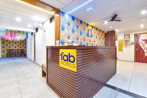 a hotel lobby with a tabo hotels sign on a reception desk at FabHotel Vishwa in Ahmedabad