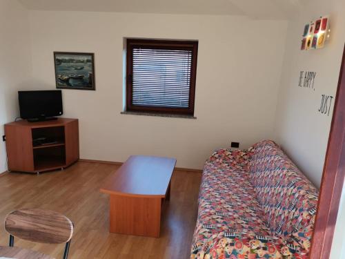 a living room with a couch and a table at Appartement Sonia in Fažana