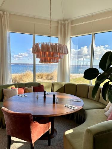 a living room with a table and a couch at Marienlyst Strandhotel in Helsingør