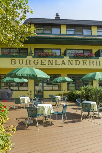 a group of tables and chairs in front of a building at Burgenländerhof Hotel Garni in Mörbisch am See