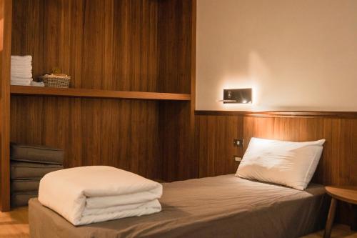 Un dormitorio con una cama con toallas blancas. en 秀川居 Xiuchuanju en Sanxia