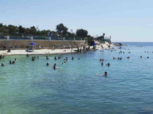 a group of people in the water at a beach at Amethyst in Marsaskala