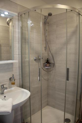 a bathroom with a shower and a sink at Apartmány U Zvoničky in Prachov