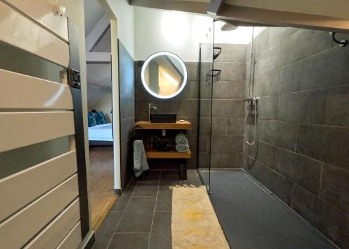 a bathroom with a shower and a mirror at 23 in Soulac-sur-Mer